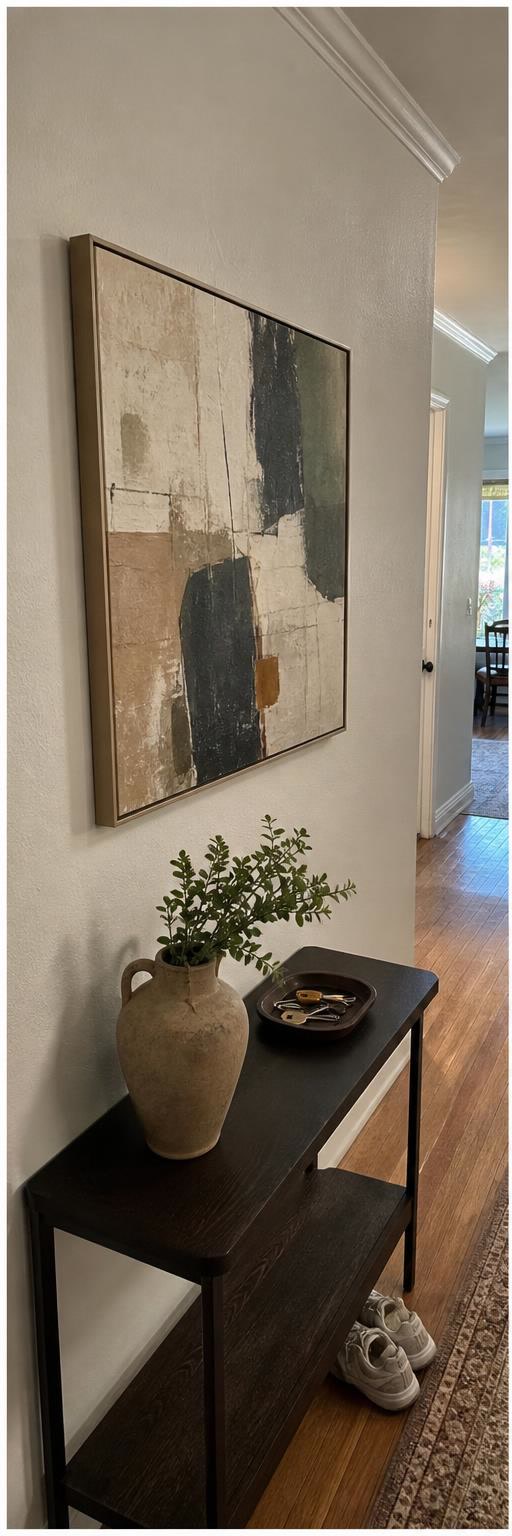 Framed abstract canvas in a lived-in hallway