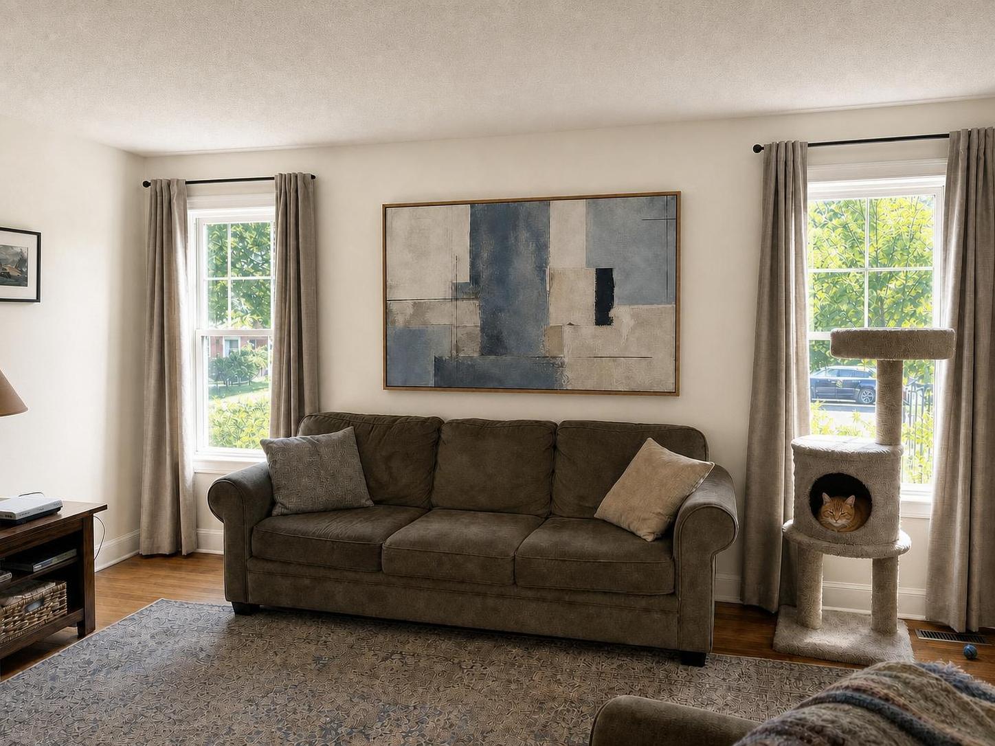 Blue Ridge Wash framed canvas between two windows in a bright lived-in living room